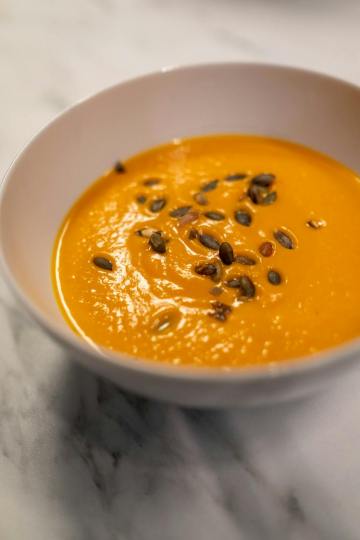 pumpkin soup in white ceramic bowl